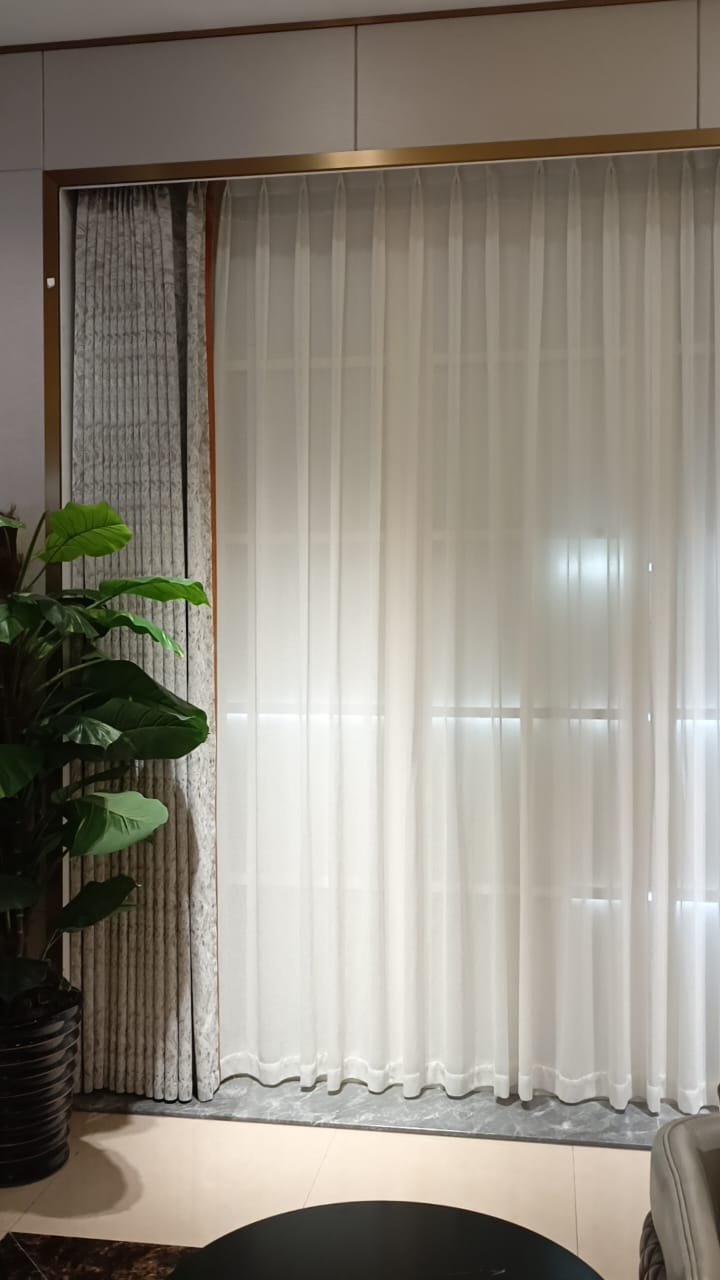 Elegant floor-to-ceiling sheer curtains with layered window treatment in modern interior